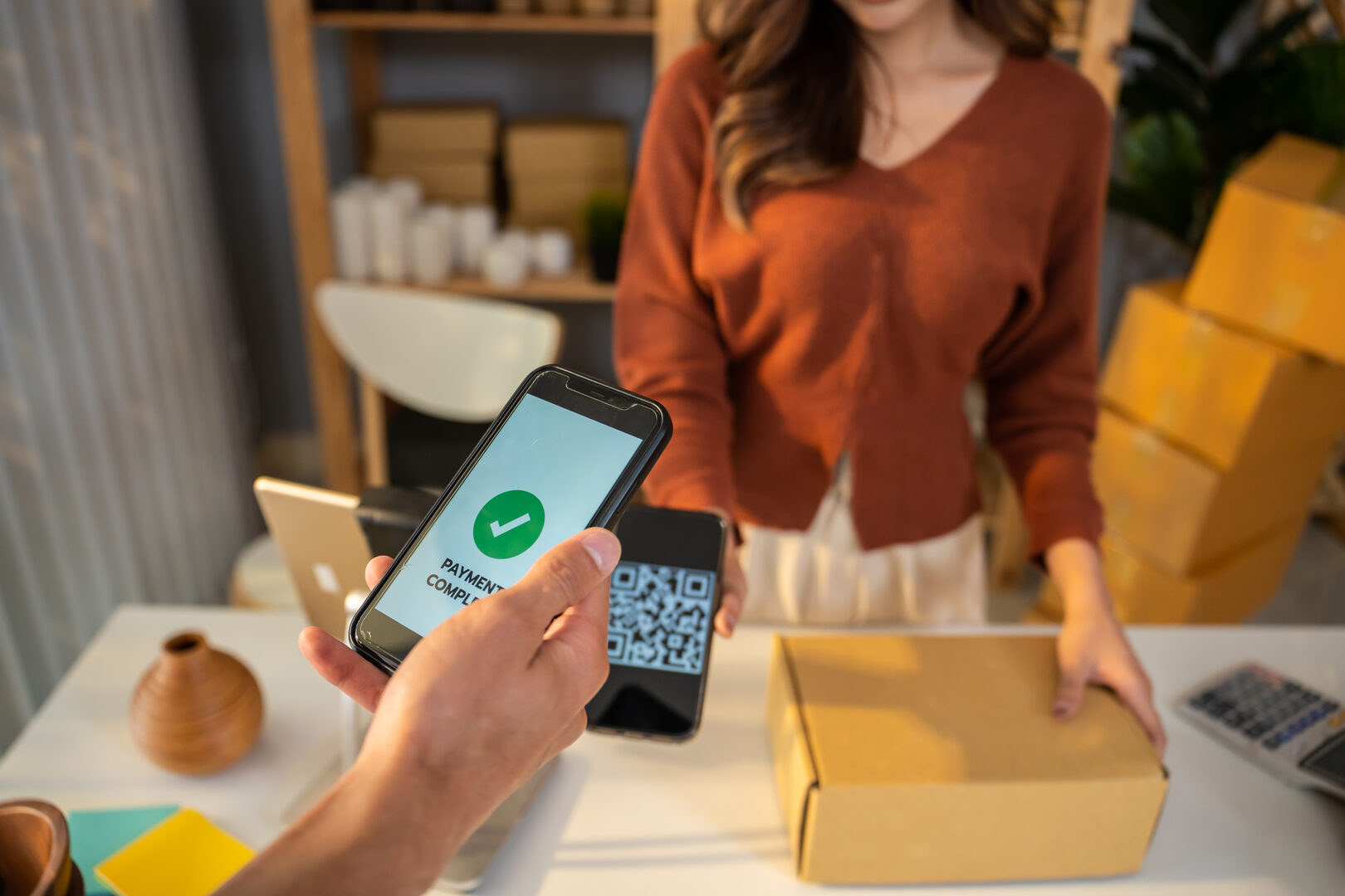 Customer scanning QR code for payment on mobile phone